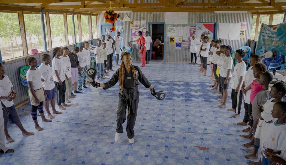 Coach Caroline Ambani leads a Taekwondo class in Kakuma Refugee Camp.